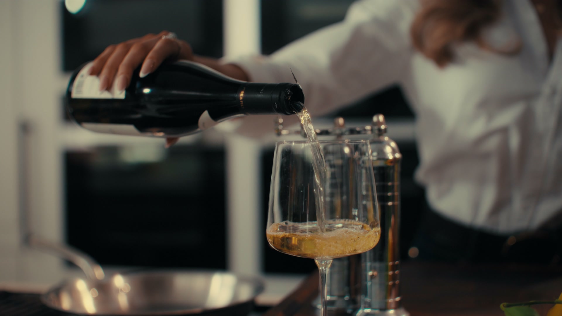 A glass of chilled white wine being poured in the Nikki Home kitchen